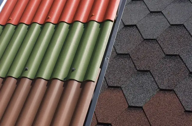 Samples of colored corrugated roofing beside dark shingle pieces
